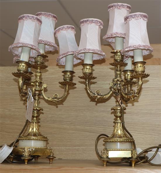 A pair of four branch gilt metal lamps